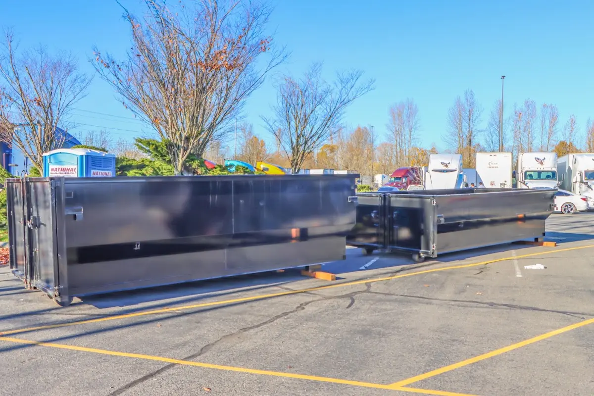 Professional dumpster rental service with roll-off container on residential driveway in Cypress Gardens